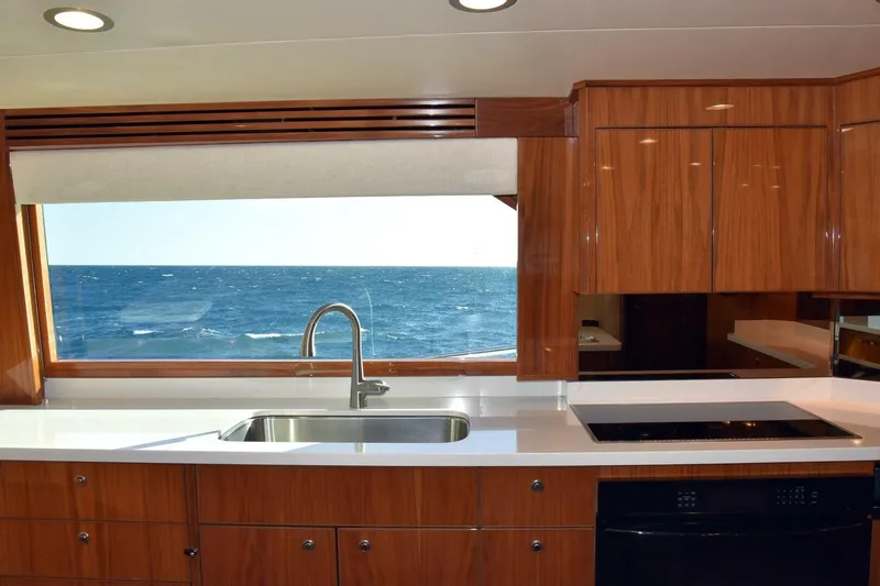  Yacht Photos Pics Luxurious kitchen interior of 2019 Viking 80 Skybridge yacht with ocean view.