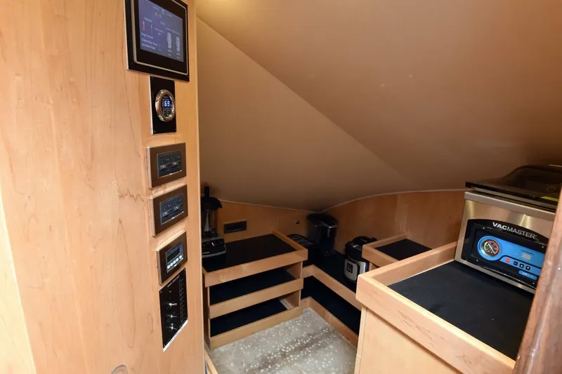  Yacht Photos Pics 2019 Viking 80 Skybridge yacht interior with control panels and storage shelves.