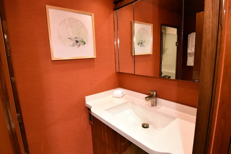  Yacht Photos Pics Luxurious bathroom in 2019 Viking 80 Skybridge yacht with modern sink and fish artwork.