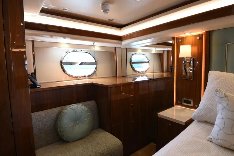  Yacht Photos Pics Luxurious interior of 2019 Viking 80 Skybridge yacht with elegant wood finish and porthole window.