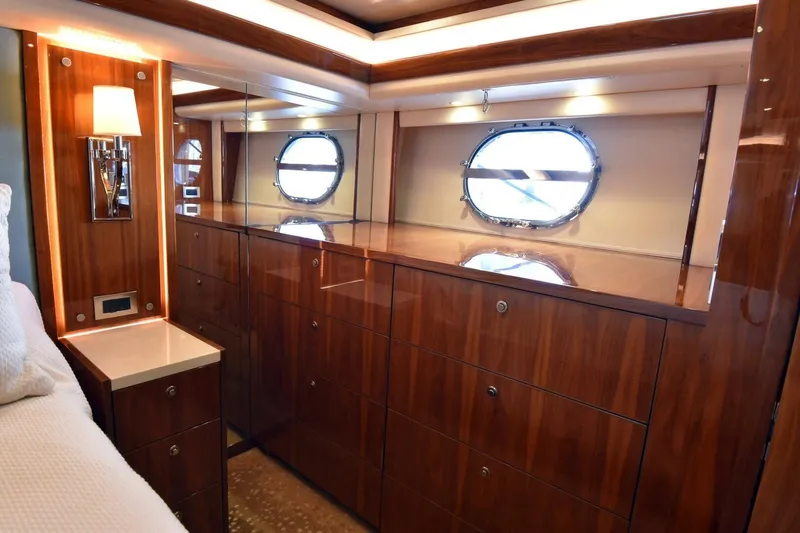 Yacht Photos Pics Luxurious wood interior of 2019 Viking 80 Skybridge yacht cabin with porthole window.
