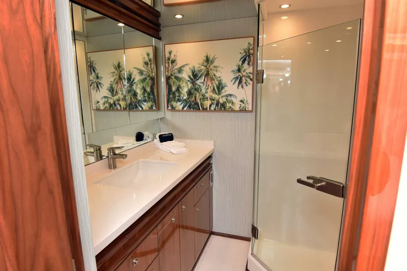  Yacht Photos Pics Luxurious bathroom in 2019 Viking 80 Skybridge yacht with modern fixtures and palm tree artwork.