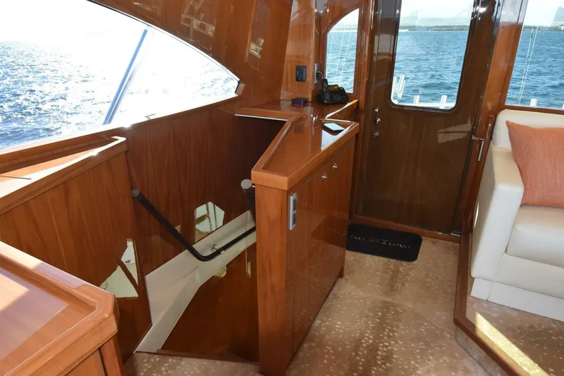  Yacht Photos Pics Luxurious interior of 2019 Viking 80 Skybridge yacht with polished wood and ocean view.