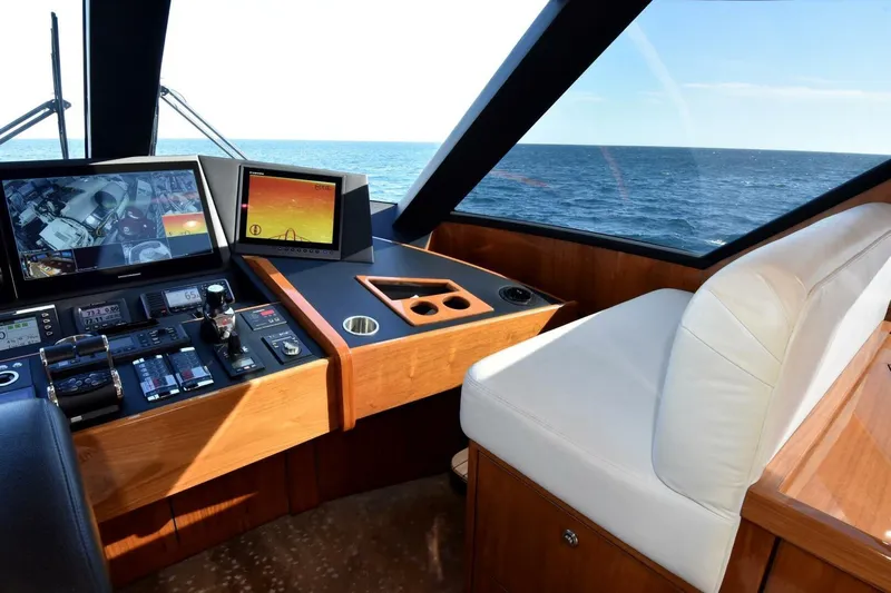  Yacht Photos Pics Interior helm of 2019 Viking 80 Skybridge yacht with navigation screens and ocean view.