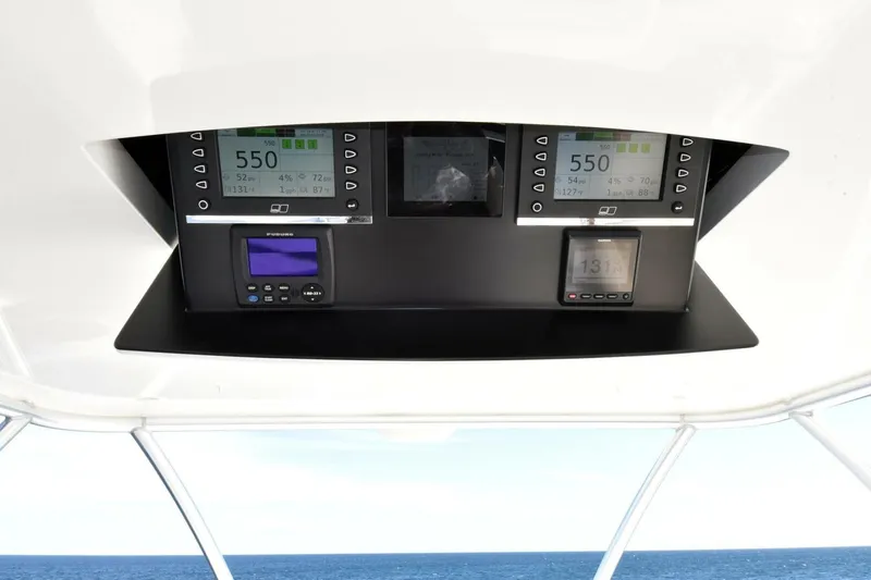  Yacht Photos Pics Control panel of 2019 Viking 80 Skybridge yacht with ocean view in background.