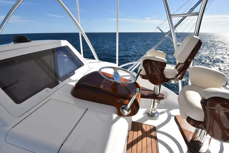  Yacht Photos Pics 2019 Viking 80 Skybridge yacht helm with luxurious seating and ocean view.