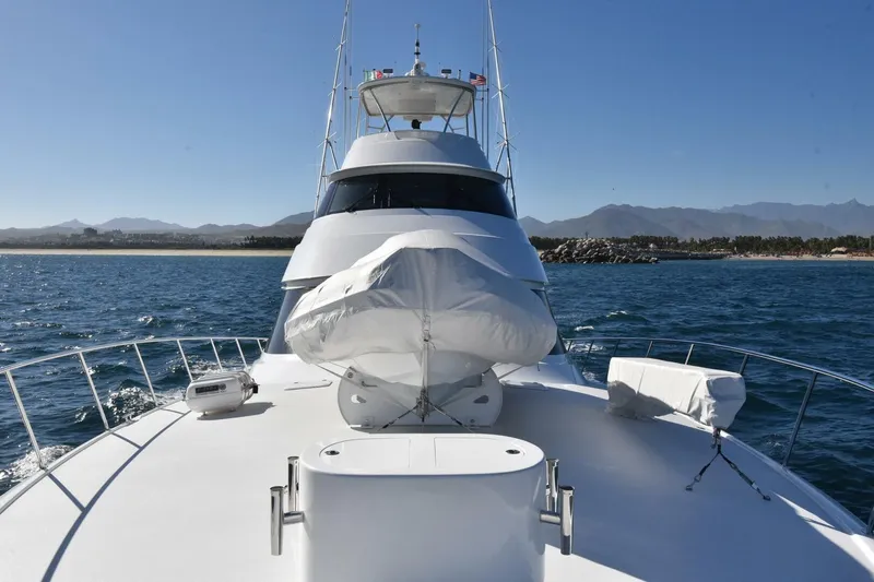  Yacht Photos Pics 2019 Viking 80 Skybridge yacht cruising on open water with scenic coastline backdrop.