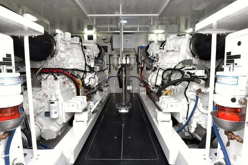  Yacht Photos Pics Engine room of 2019 Viking 80 Skybridge yacht, showcasing dual engines and mechanical systems.