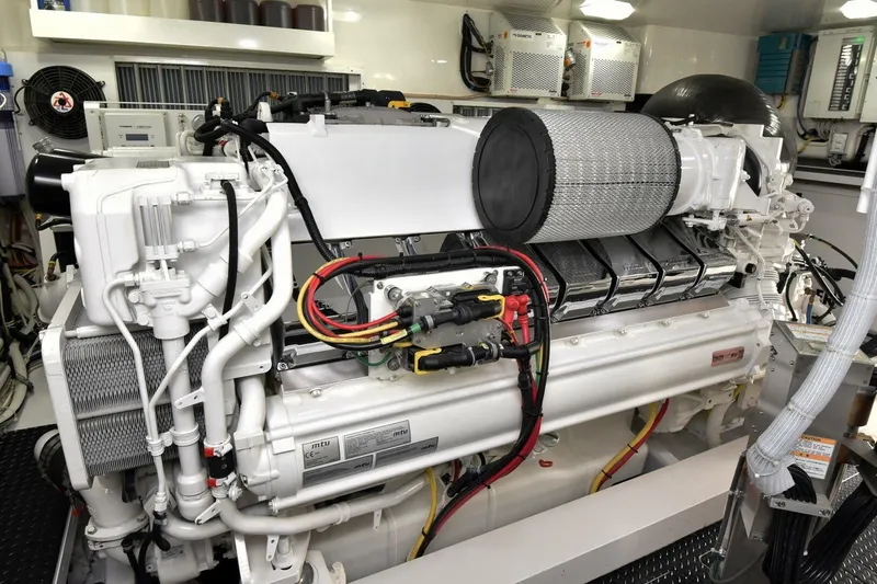  Yacht Photos Pics Engine room of a 2019 Viking 80 Skybridge yacht, showcasing a powerful marine engine.