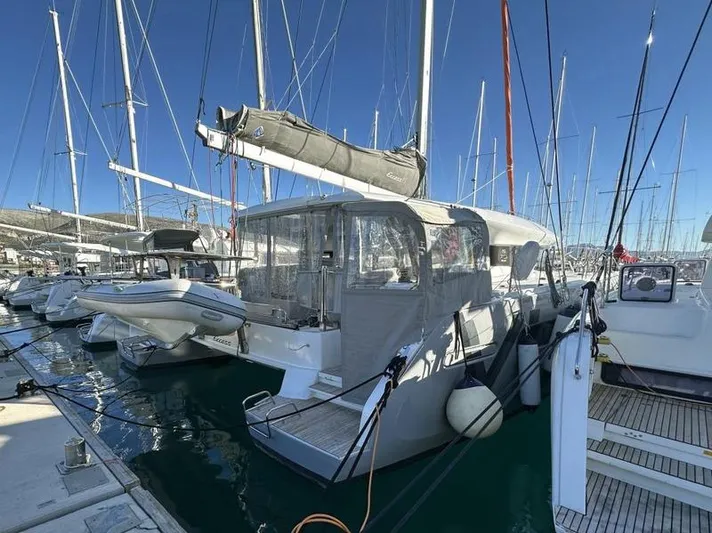 Tranquillity Yacht Photos Pics 2022 Excess 15 catamaran docked in marina, surrounded by other boats under clear blue sky.