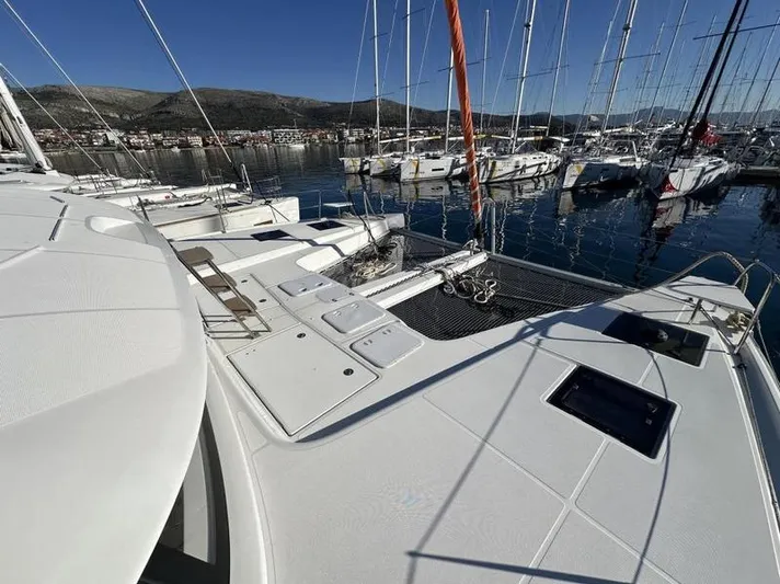 Tranquillity Yacht Photos Pics Excess 15 catamaran docked in marina, 2022 model, with clear blue sky and surrounding boats.