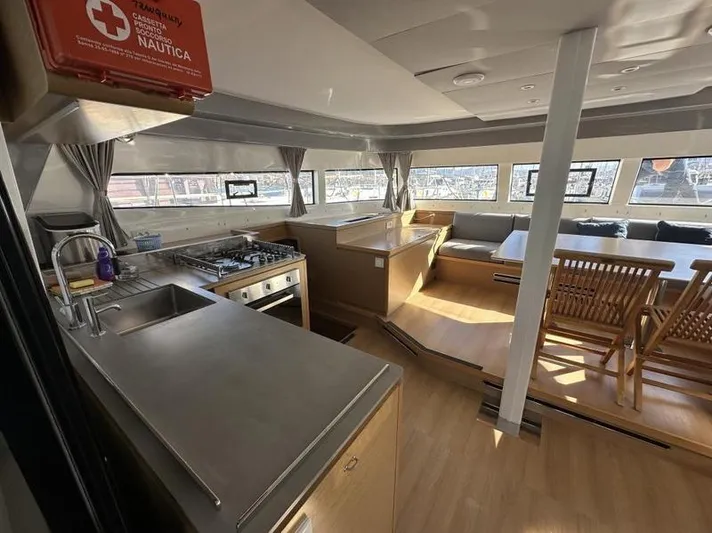 Tranquillity Yacht Photos Pics Luxurious interior of 2022 Excess 15 yacht with kitchen and seating area.