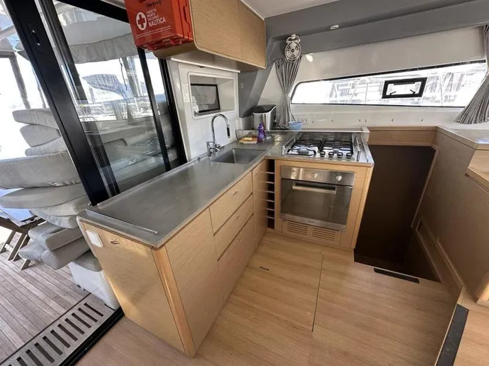 Tranquillity Yacht Photos Pics Modern kitchen in 2022 Excess 15 yacht with stainless steel appliances and wooden cabinetry.