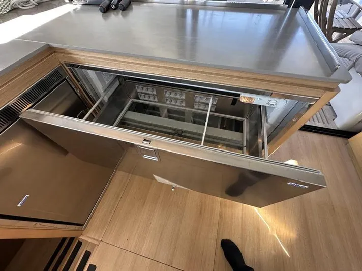 Tranquillity Yacht Photos Pics Modern kitchen drawer refrigerator in a 2022 Excess 15 yacht interior.