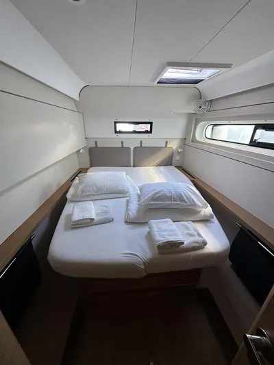 Tranquillity Yacht Photos Pics Cozy cabin interior of 2022 Excess 15 yacht with neatly arranged bed and linens.