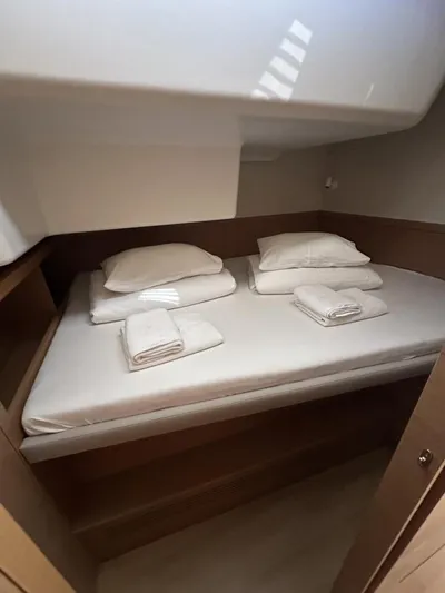 Tranquillity Yacht Photos Pics Cozy cabin bed with neatly arranged linens in a 2022 Excess 15 yacht.