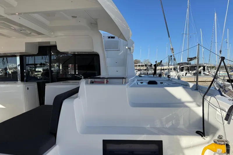  Yacht Photos Pics Modern 2022 Lagoon 46 catamaran docked at marina, showcasing sleek design and spacious deck.