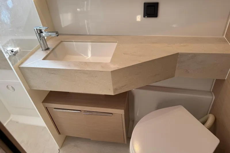  Yacht Photos Pics Modern bathroom in 2022 Lagoon 46 yacht with sleek sink and storage.