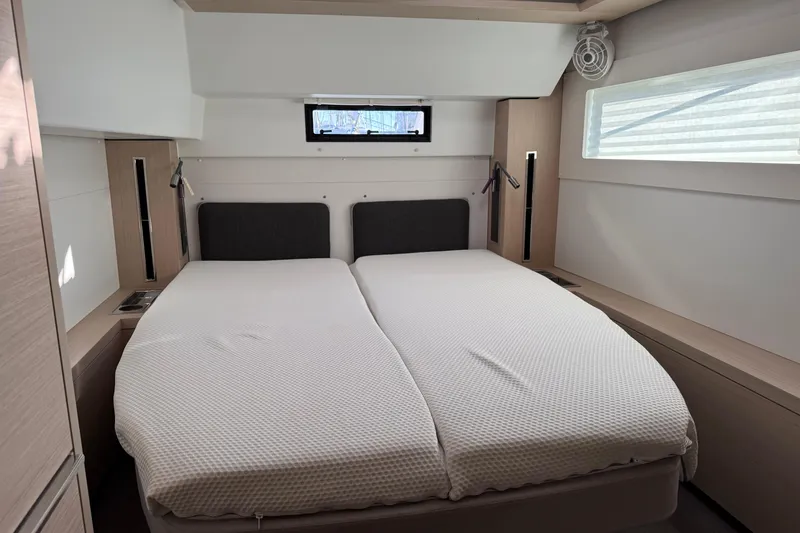  Yacht Photos Pics Interior cabin of 2022 Lagoon 46 catamaran with twin beds and modern design.
