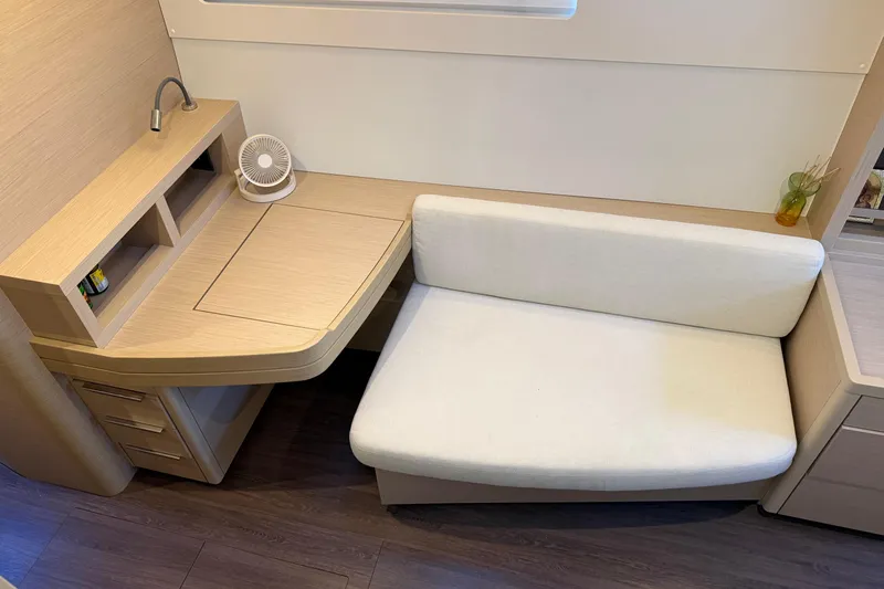  Yacht Photos Pics Modern interior of 2022 Lagoon 46 yacht with desk and sofa.