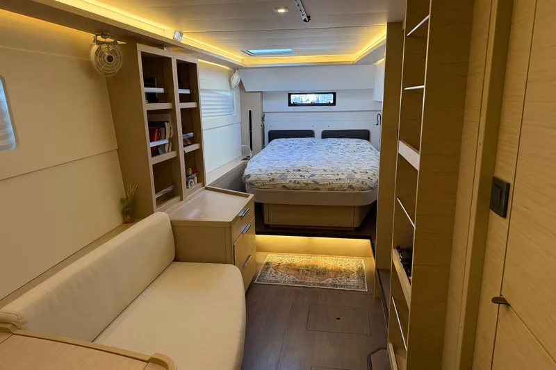 Yacht Photos Pics Luxurious interior of 2022 Lagoon 46 yacht with cozy bedroom and modern furnishings.