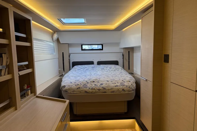  Yacht Photos Pics Luxurious interior cabin of 2022 Lagoon 46 yacht with cozy bed and ambient lighting.