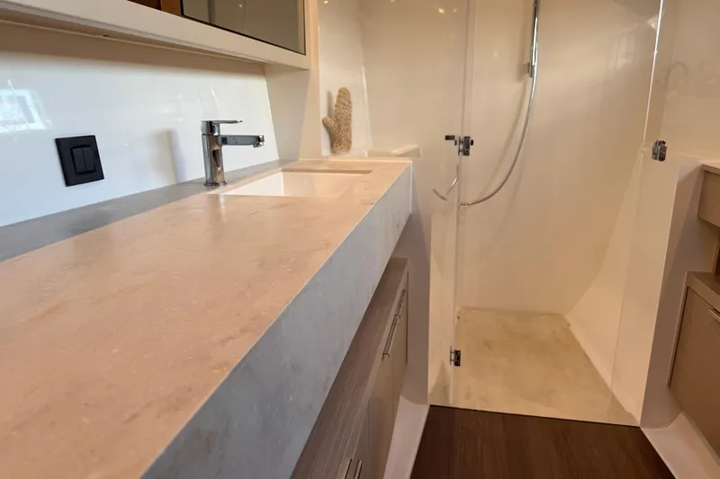  Yacht Photos Pics Modern bathroom interior of 2022 Lagoon 46 yacht with sleek sink and shower.