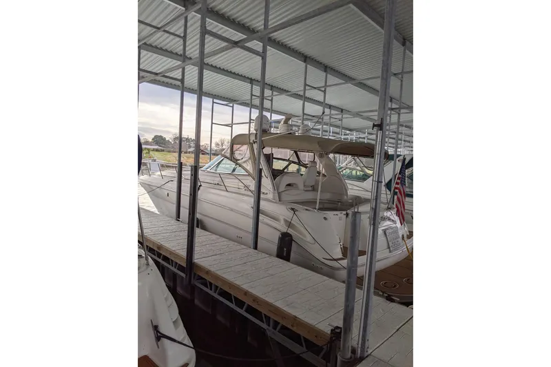 Lottie-da Yacht Photos Pics 2004 Sea Ray 380 Sundancer docked under a covered marina.