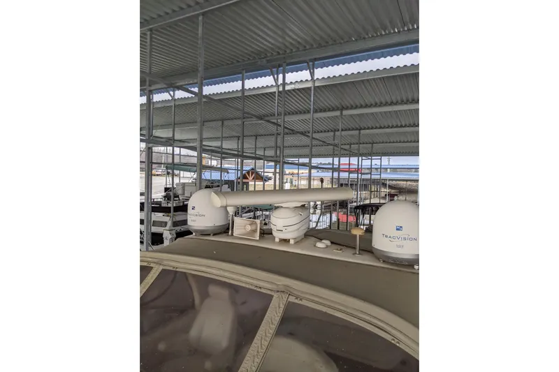 Lottie-da Yacht Photos Pics 2004 Sea Ray 380 Sundancer docked under covered marina with satellite equipment.