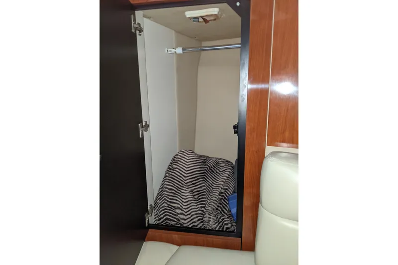 Lottie-da Yacht Photos Pics Open closet in 2004 Sea Ray 380 Sundancer with striped blanket inside.
