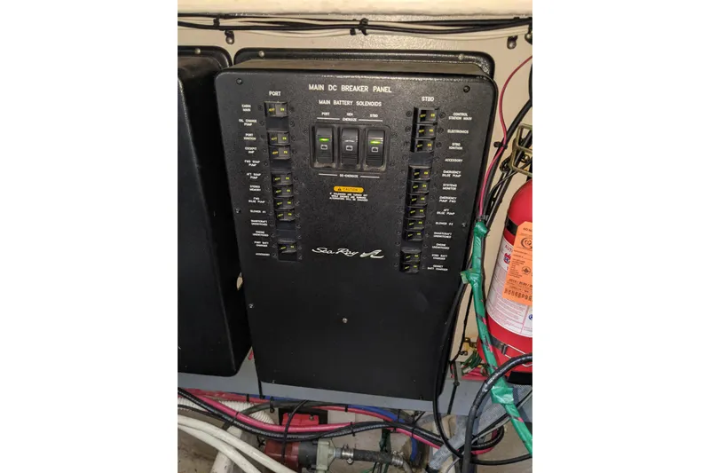 Lottie-da Yacht Photos Pics Main DC breaker panel on 2004 Sea Ray 380 Sundancer boat, with fire extinguisher nearby.