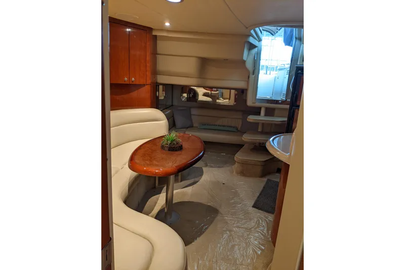 Lottie-da Yacht Photos Pics Interior of 2004 Sea Ray 380 Sundancer yacht with elegant seating and wooden table.