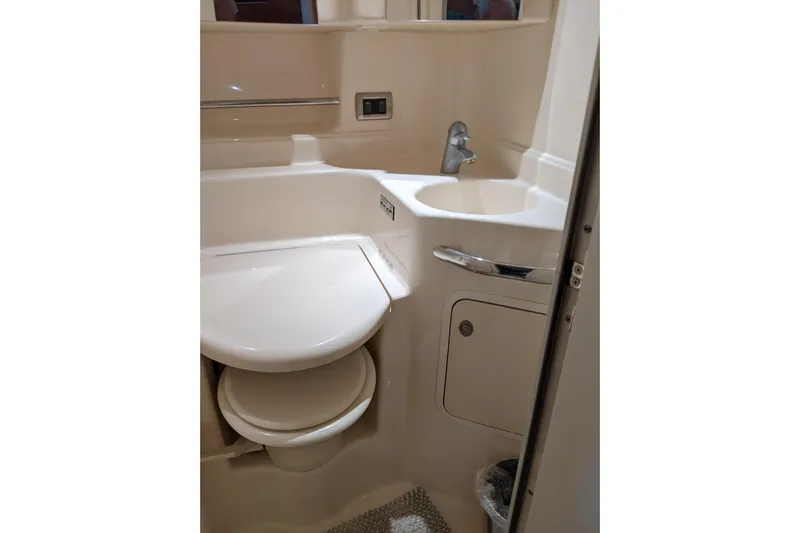 Lottie-da Yacht Photos Pics Bathroom interior of 2004 Sea Ray 380 Sundancer yacht, featuring sink and toilet.