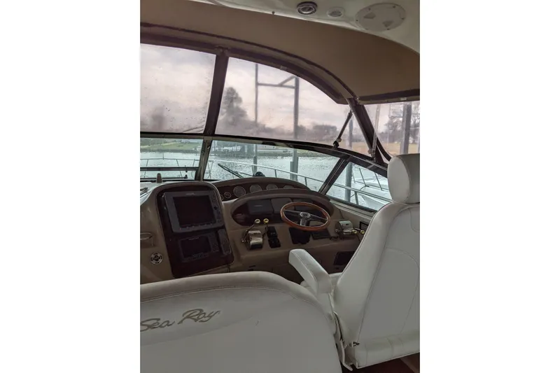 Lottie-da Yacht Photos Pics 2004 Sea Ray 380 Sundancer helm with steering wheel and navigation controls.