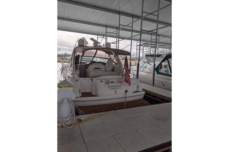 Lottie-da Yacht Photos Pics 2004 Sea Ray 380 Sundancer docked in a covered marina, rear view.