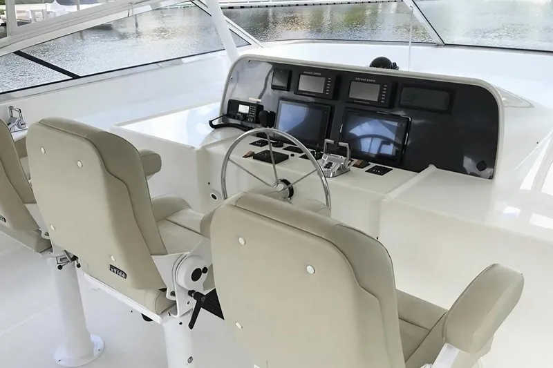 Harbor Lady Yacht Photos Pics 2005 Pacific Mariner Raised Pilothouse Motor Yacht helm with dual seats and navigation equipment.