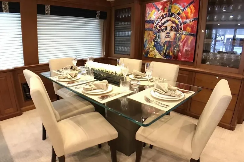 Harbor Lady Yacht Photos Pics Luxurious dining area on 2005 Pacific Mariner yacht with elegant table setting and vibrant artwork.