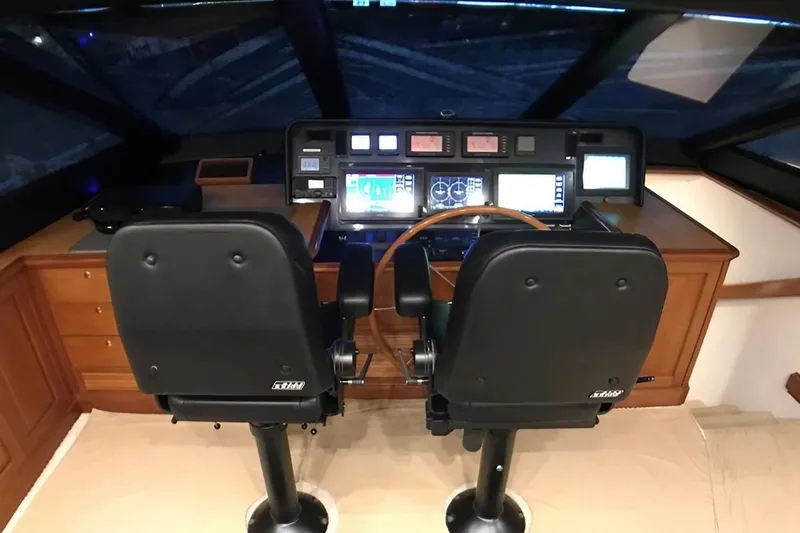 Harbor Lady Yacht Photos Pics Pilothouse interior of 2005 Pacific Mariner Raised Pilothouse Motor Yacht with dual seats and control panel.