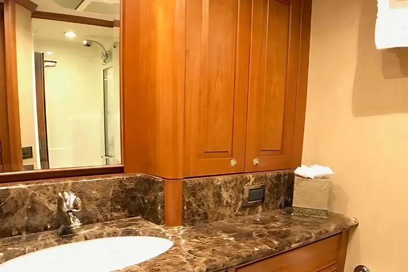 Harbor Lady Yacht Photos Pics Luxurious bathroom in 2005 Pacific Mariner yacht with marble countertop and wooden cabinetry.