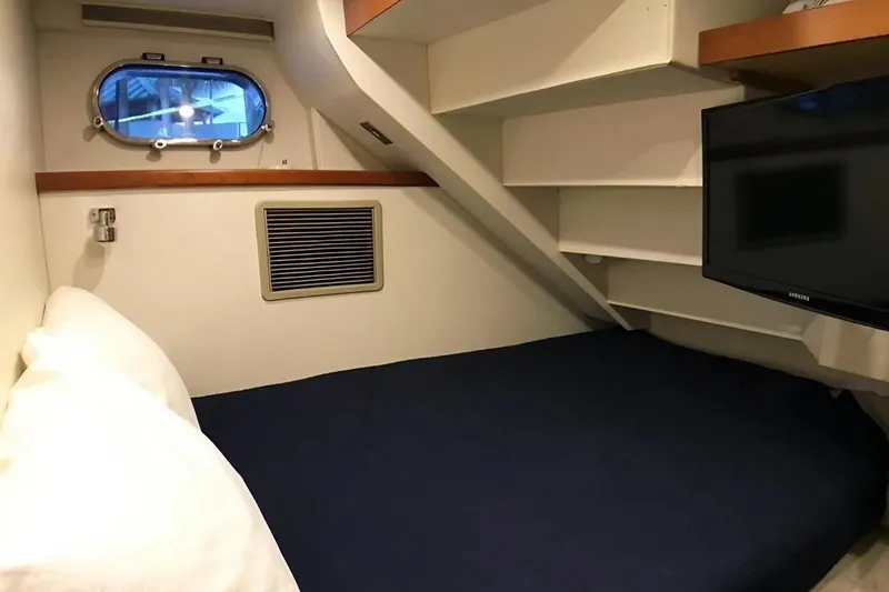 Harbor Lady Yacht Photos Pics Cozy cabin interior of 2005 Pacific Mariner Raised Pilothouse Motor Yacht with bed and TV.