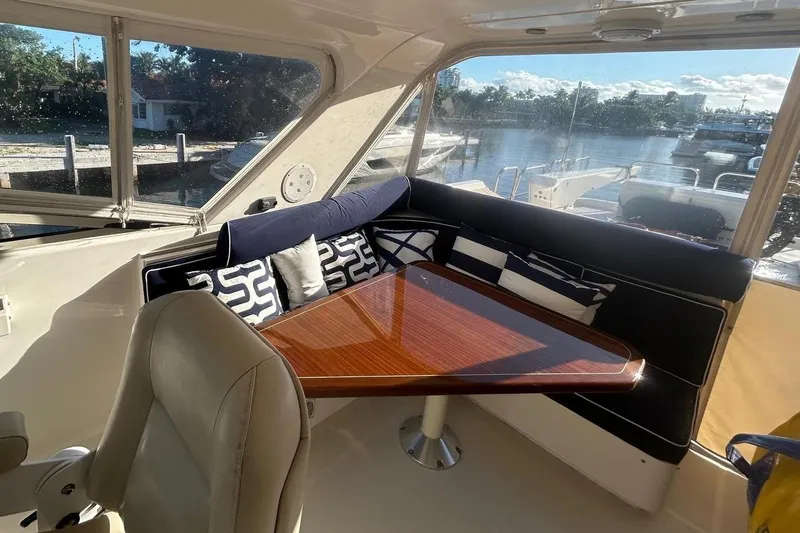 Harbor Lady Yacht Photos Pics Luxurious interior of 2005 Pacific Mariner Raised Pilothouse Motoryacht with elegant seating and table.