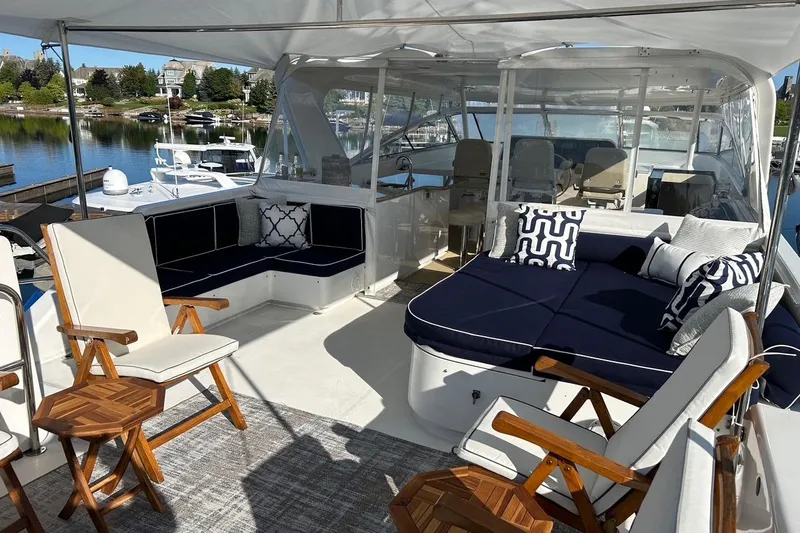 Harbor Lady Yacht Photos Pics Luxurious 2005 Pacific Mariner Raised Pilothouse Motoryacht with elegant outdoor seating and scenic marina view.