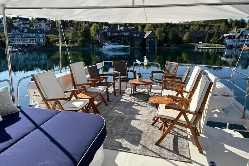 Harbor Lady Yacht Photos Pics Luxurious 2005 Pacific Mariner yacht deck with elegant seating, overlooking serene waterfront homes.