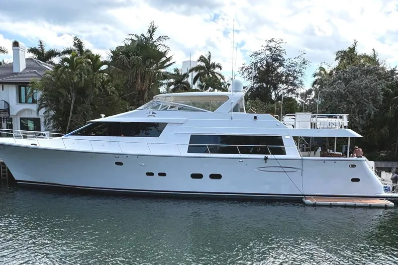 Harbor Lady Yacht Photos Pics 2005 Pacific Mariner Raised Pilothouse Motoryacht docked by lush greenery.