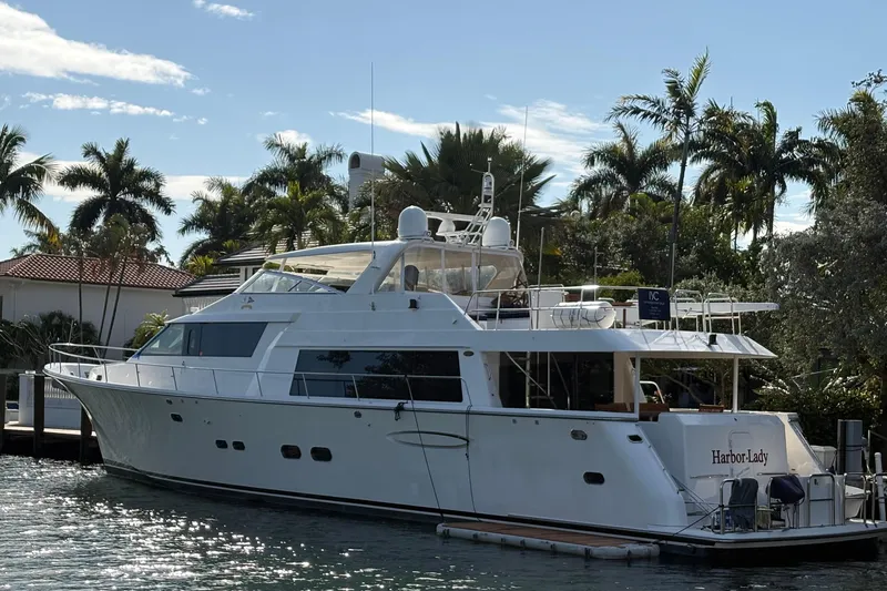 Harbor Lady Yacht Photos Pics 2005 Pacific Mariner Raised Pilothouse Motoryacht docked near palm trees.
