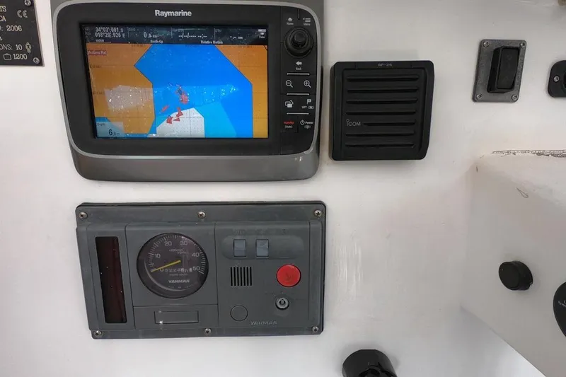 Conquest Yacht Photos Pics Control panel of a 2006 Maxim Yachts 57 with navigation display and gauges.