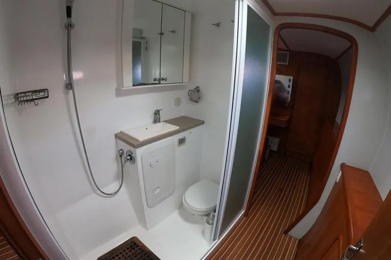 Conquest Yacht Photos Pics Bathroom interior of 2006 Maxim Yachts 57, featuring shower, sink, and toilet.