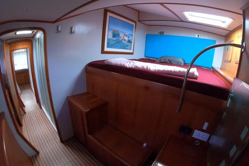 Conquest Yacht Photos Pics Luxurious cabin interior of 2006 Maxim Yachts 57 with wooden finish and cozy bed.