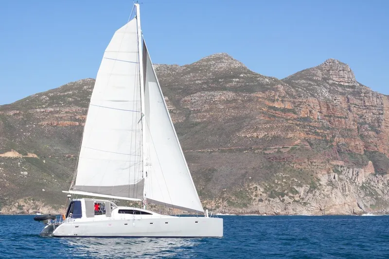 Conquest Yacht Photos Pics Sailing yacht Maxim Yachts 57, 2006 model, cruising near rocky coastline.