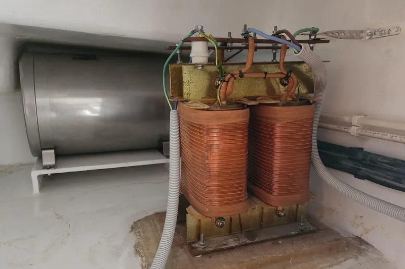 Conquest Yacht Photos Pics Electrical components inside a 2006 Maxim Yachts 57, featuring copper coils and wiring.